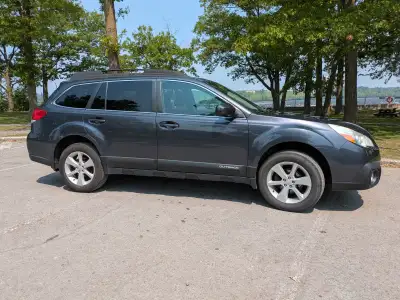 Low-milage and accident-free Outback with heated seats, integrated roof crossbars, and factory fog l...