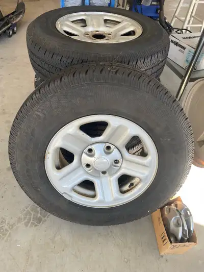reduced!!!Set of 4 jeep rims, center caps, lug nuts and tires. Good shape, lots of tread. Only winte...