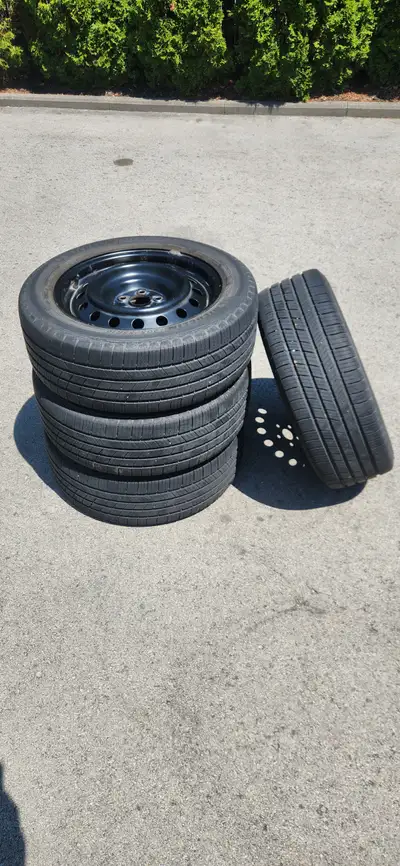 4 Michelin Defender tires 205/55R16. 6-7mm tread remaining. Mounted on Toyota Corolla factory rims....