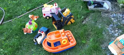 Well used outdoor vehicles. One is a Tonka but it is rusting. Good for playing in a sandbox or dirt....