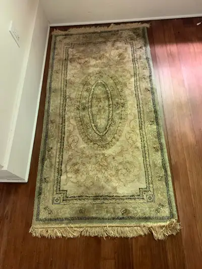 This traditional area rug features a timeless, ornate design with a central oval motif and intricate...