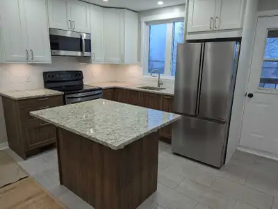 This modern 1 bedroom apartment features an updated kitchen with a functional island, brand new stai...