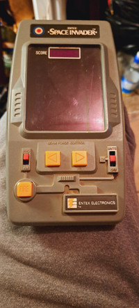 1981 entex space invaders hand held arcade game,.