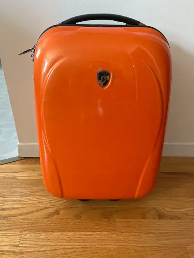 Small hard shell suitcase with light up wheels and extendable handle. No cracks. Good condition. Rea...