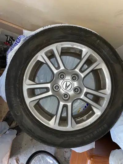 Four Acura alloy rims with Pirelli All Season tires sized at 245/50R17 99V. Rims: ACURA (Honda) TK 4...