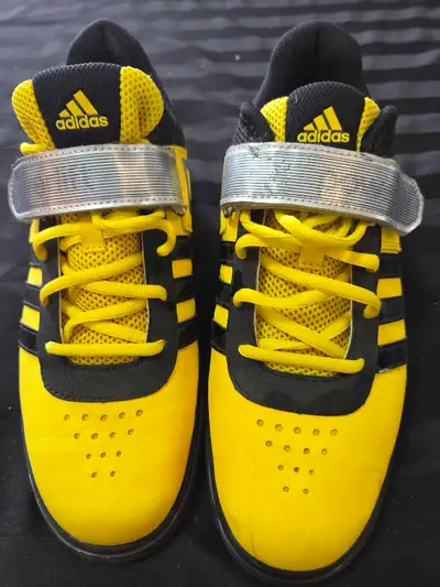 Step up your training with these yellow and black Adidas Powerlift weightlifting shoes, size US 9. T...