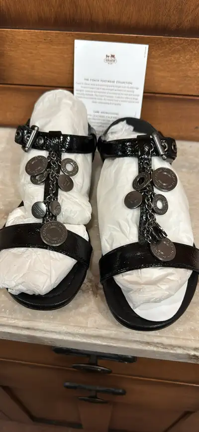 Step into style with these pristine Coach Stella sandals, size 7.5. These chic black sandals feature...