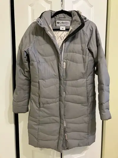 This is a used Columbia Titanium winter coat for women, size medium. It's designed to withstand cold...