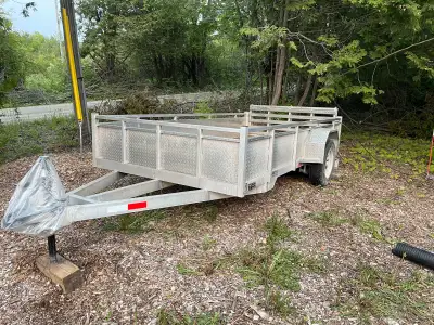 2022 Welded utility trailer 1 owner. 3500 lb axle bi-fold gate 16” checker plate side walls galvaniz...