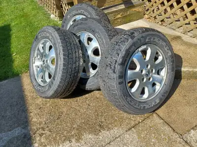 4 14" Chevy style rally rims on Cooper Cobra Radial GT Tires with trim rings and caps asking $1,200....