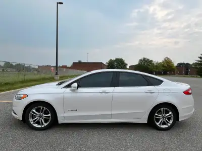 2016 Ford Fusion Hybrid, 97000kms, White, with black seats, fully equipped. Has rear camera and sens...
