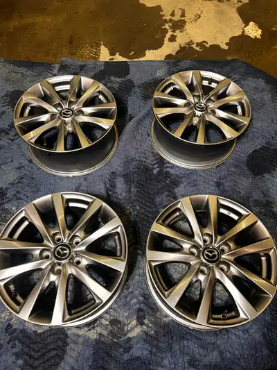Mazda OEM 16” Alloy Rim (Dark Grey Metallic) Brand new never used. Set of 4 $600 obo