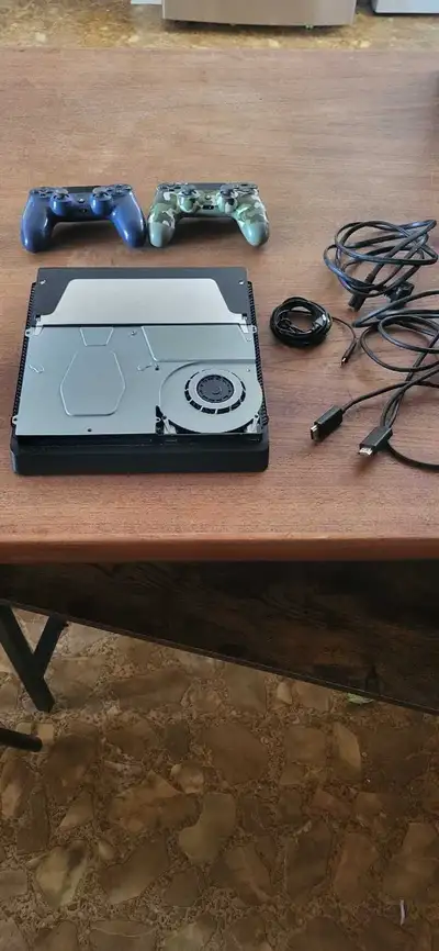 Ps4 with 2 controllers and all the cables. Console is missing cover but works well otherwise. Some g...