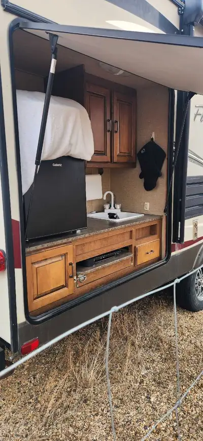 For sale 2013 camper 26 feet couple's coach. has out side kitchen couch with recliners. Power awning...