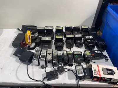 This is a comprehensive collection of used camera flashes, ideal for photography enthusiasts and col...