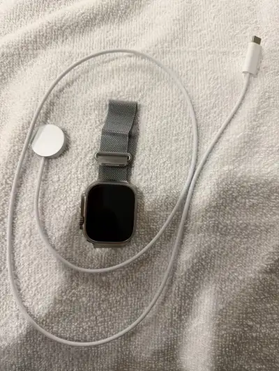 Apple watch ultra natural titanium with charger and strap on gre, View more