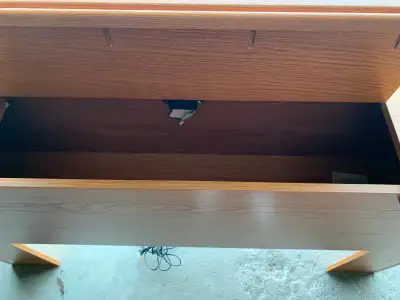 A solid heavy wood headboard with built in storage (for audio) flip lid compartment. It's in good sh...