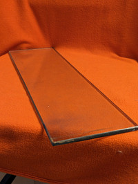 One flat solid piece of 0.25 inch tempered glass