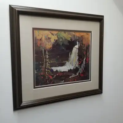Enhance your home decor with this charming framed Tom Thomson art print, showcasing a serene waterfa...