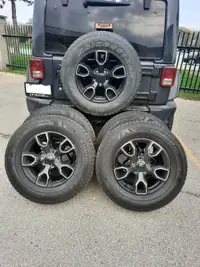 5 Jeep rims and tires
