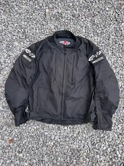 The Atomic™ motorcycle jacket from Joe Rocket Canada® is made with a combination Rock Tex™ 600 and R...