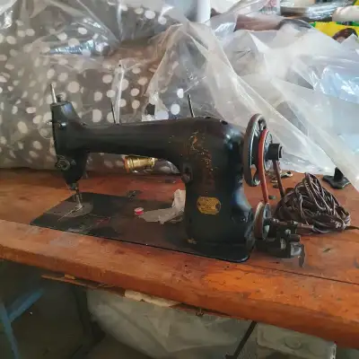 This vintage Singer sewing machine, with its classic black finish, is a piece of history ready to be...