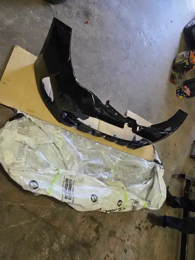 A brand new OEM front bumpe, painted pearl black. we needed a rear one and never looked at it and se...