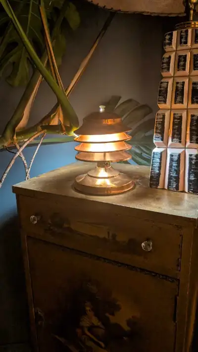 Illuminate your space with this charming vintage copper table lamp, a unique piece that adds a touch...