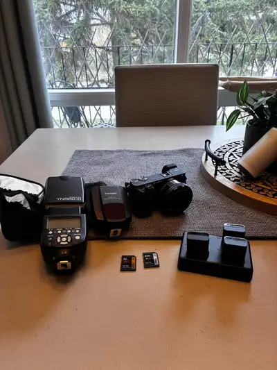 Sony a6400 camera with kit lens, 4 batteries, 2 memory cards , battery charger, external flash and t...