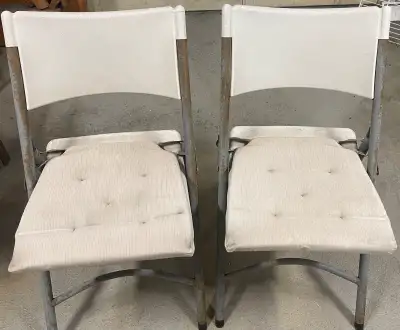 Add some vintage charm to your seating arrangement with these two used, white folding chairs. Perfec...
