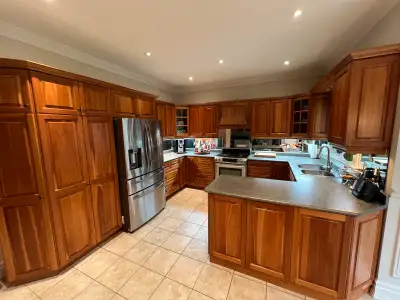 $2,000 OR BEST OFFER! Full set of cherry wood kitchen cabinets. Including all countertops, hardware...