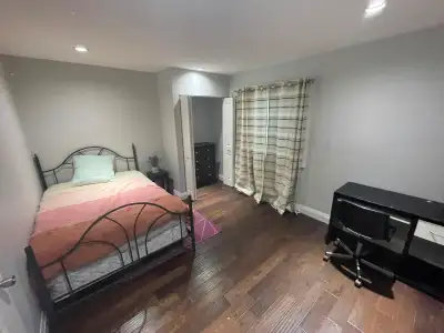 Furnished bedroom with a mini fridge, shared bathroom and kitchen. Location is in North Side McConac...