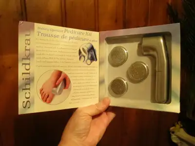 Pedicure Kit, battery operated, in titanium color. Comes with three different discs. Still new in bo...