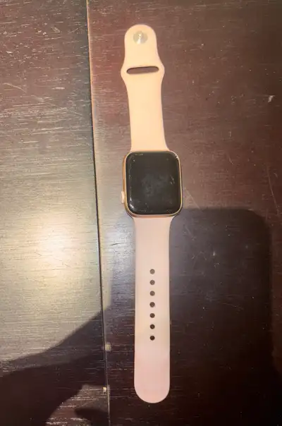 Apple Watch Series 5. 44 mm. Gold aluminum case. Pink sand sport band. Watch comes with the box.