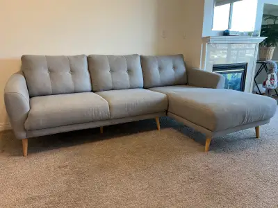 Upgrade your living space with this stylish and comfortable grey sectional sofa, perfect for loungin...