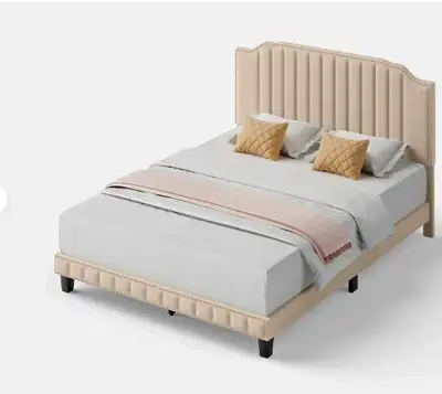 Add comfort and modern elegance to your bedroom with this queen-sized upholstered bed frame featurin...
