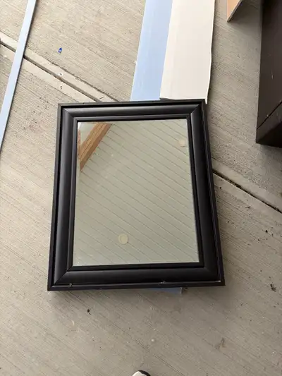 This is a used mirror and vanity set that includes a dark brown vanity with a white sink, as well as...