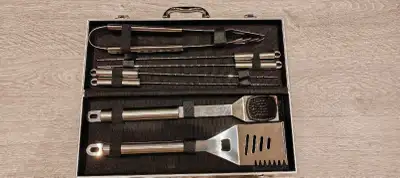 Elevate your grilling game with this comprehensive BBQ tool set, neatly organized in a sturdy carryi...