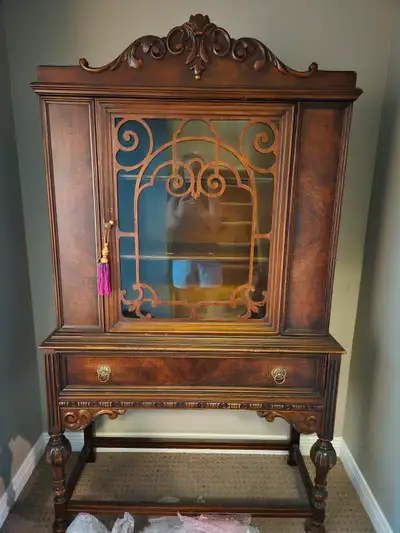 Beautiful antique china cabinet with glass door front and large drawer.