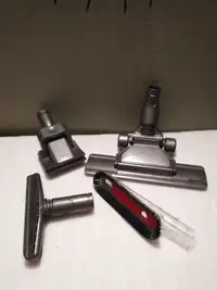 Assorted brand new Dyson vacuum attachments.