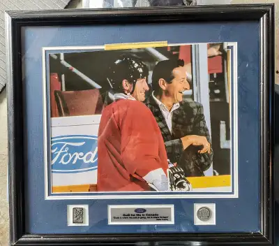 This is a framed photograph of Wayne Gretzky and his father Walter Gretzky, the photo is accompanied...