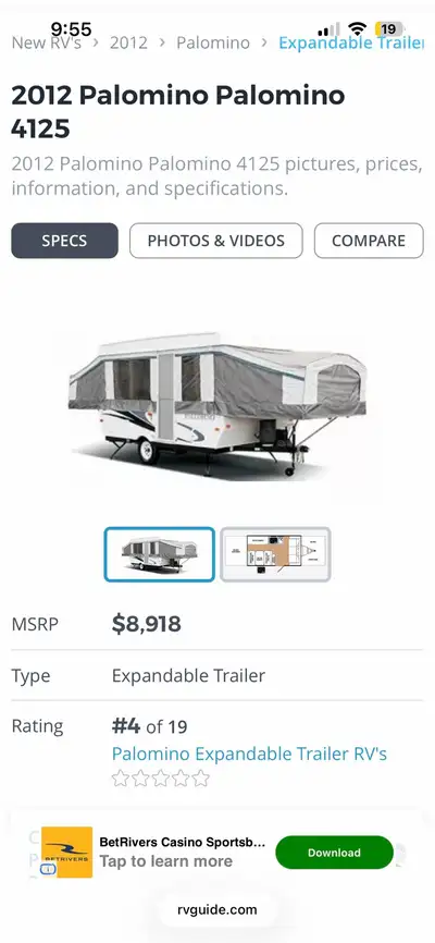 Spacious Palomino pop-up camper has a white exterior with black and grey graphics. The interior feat...