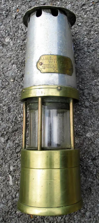 Vintage Miner's light 10 inches high and in good condition. The light is stamped JH Waylor Wigan 188...