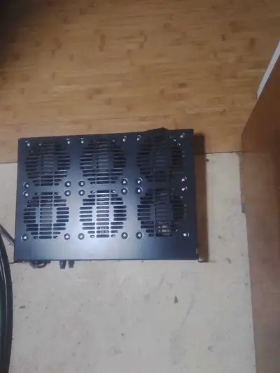 A bank of high speed cooling fans enclosed in a metal cabinet measures 17 1/4" x 12" x 1 3/4" about...