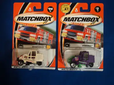 This lot includes a cream (#96) and a purple (#3) Hydromax. Both bottom corners of both cards have a...