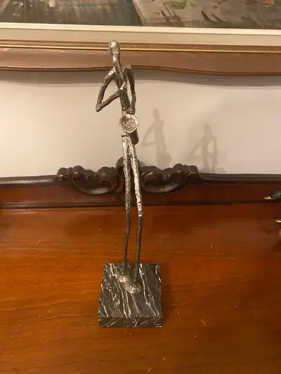 I am offering a unique brutalist metal sculpture featuring a figure playing the saxophone, mounted o...