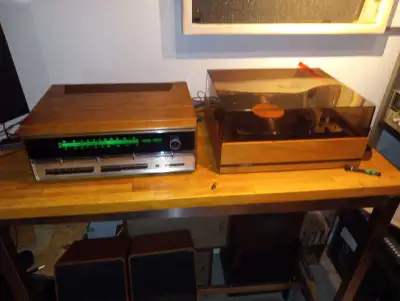 This vintage stereo system includes a receiver, turntable, and speakers, perfect for any audiophile....