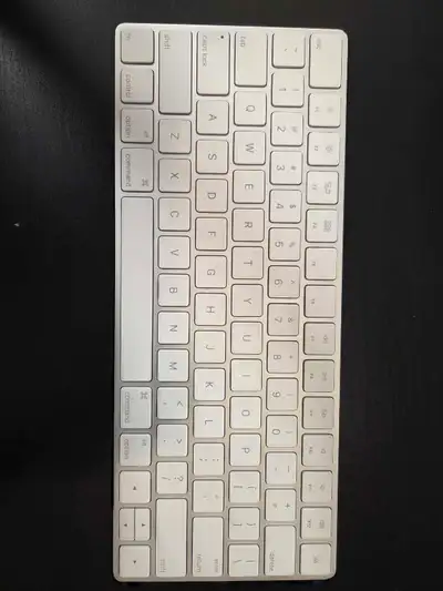 This is a used Apple Magic Keyboard, offering a sleek and wireless typing experience. This compact k...