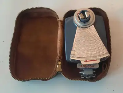 Ricoh Flash, a vintage piece of photography equipment. This flash unit comes complete with its origi...
