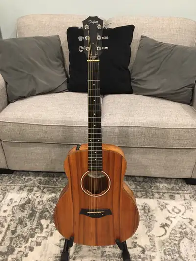 A very nice Taylor gs mini koa wood with built in factory electronics Some small marks below the tru...